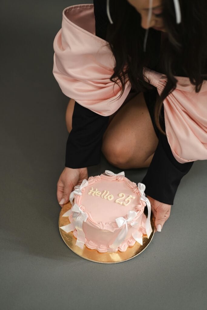 Stylish birthday celebration with a pink cake, perfect for a classy party theme.